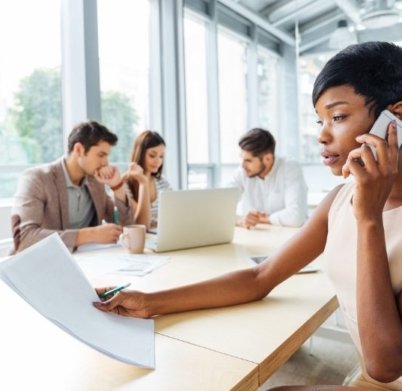 serious-businesswoman-with-documents-talking-on-P9Q6LX6@2x.jpg